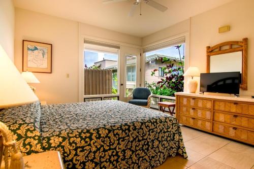 a bedroom with a bed and a tv and a mirror at Kapalua Villas Maui - Select Your Unit in Kahana