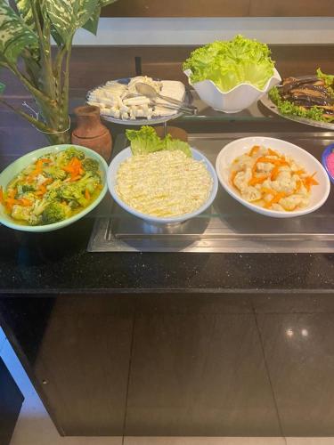a buffet with plates of food on a table at RK MAGİC DREAM HOTEL in Kemer