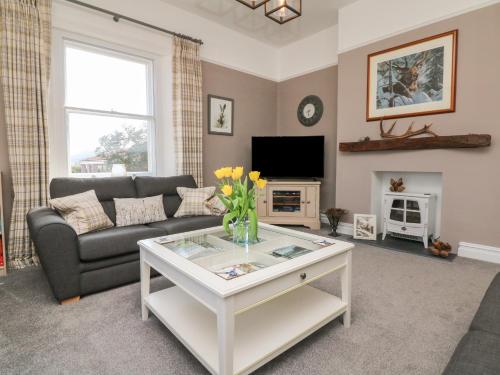 a living room with a couch and a table at The Outlook in Minehead