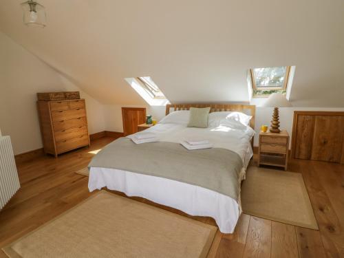 a bedroom with a large bed in a attic at Hillcroft in Kenilworth