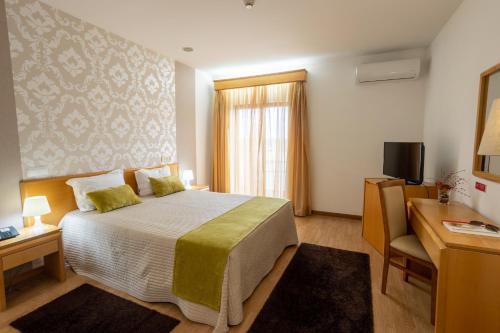 Кровать или кровати в номере Hotel Eurosol Alcanena