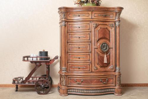 a wooden dresser with a cart next to it at Fulton Steamboat Inn in Lancaster