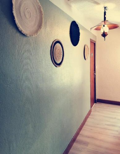 a room with plates on the wall and a hallway at Hôtel Le Lievre Blanc in Vars