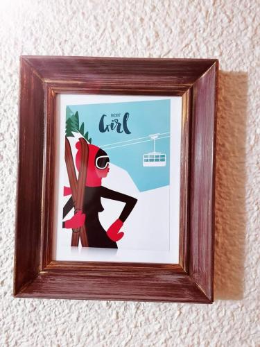 a picture of a person in a picture frame at Hôtel Le Lievre Blanc in Vars