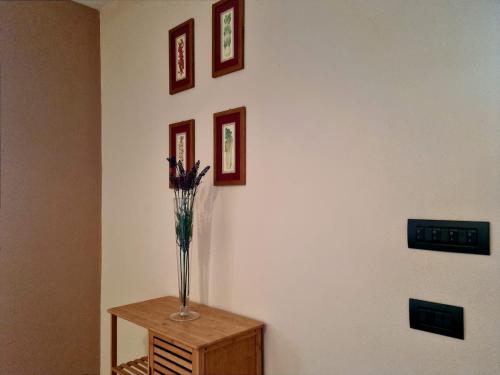 a vase of flowers on a table in a room at Arbus dune e mare in Arbus