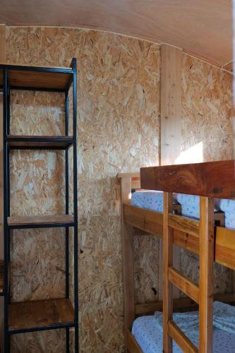 two bunk beds in a room with a wall at Tropikal Freskia Bunec in Piqeras