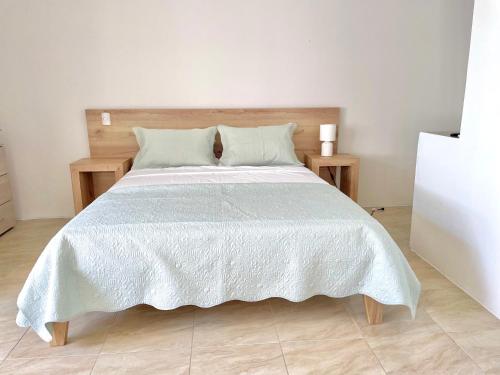 a bedroom with a large bed with a white comforter at Beautiful 2 bedroom, pool, beach in Manta