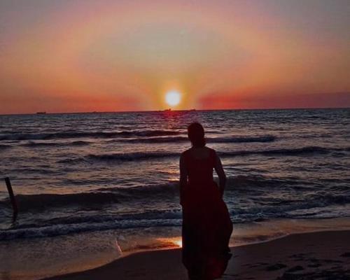 a person standing on the beach watching the sunset at Villa Dyrrahu in Golem