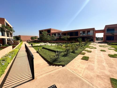 a courtyard of a building with a fence and plants at LDM Appartements Marrakech in Marrakech