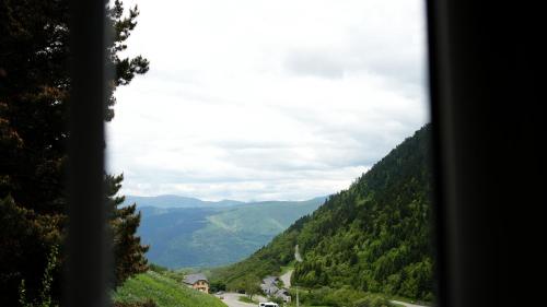 a view from a window of a valley with a road at La Sapinière in Saint-Lary-Soulan