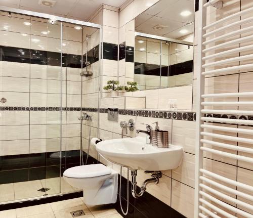 a bathroom with a white sink and a toilet at Apart-Hotels-Sofia, AHS in Sofia