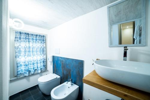 a bathroom with a sink and a tub and a toilet at Appartamento La Piazzetta in Cremona