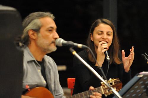 a man and a woman singing into a microphone at Simurg Evleri Olympos in Olympos