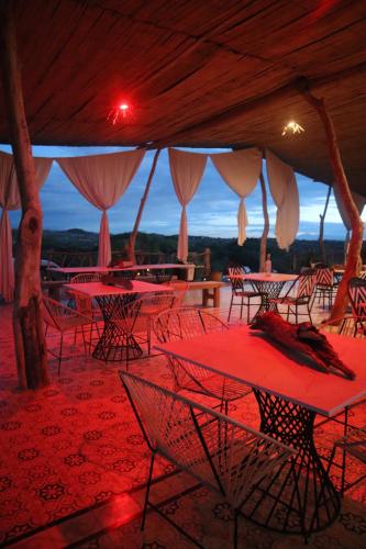a group of tables and chairs under a tent at Infinito Tatacoa in Villavieja