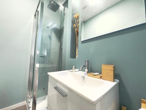 a bathroom with a white sink and a shower at KATUA Cozy Apartment - close to the downtown in Pavia
