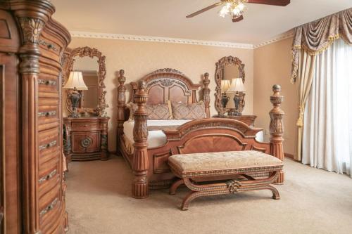 a bedroom with a large wooden bed and a dresser at Fulton Steamboat Inn in Lancaster