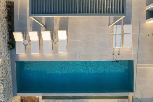 a swimming pool with blue water in a bathroom at Petras Resort in Falasarna