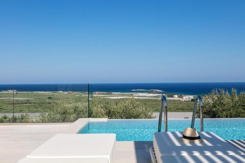 a swimming pool with a view of the ocean at Petras Resort in Falasarna