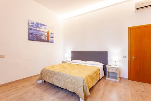 a bedroom with a bed and a wooden floor at Hotel St. James in Florence