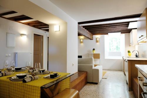 a kitchen and living room with a yellow counter top at Lisbon City Villa in Lisbon