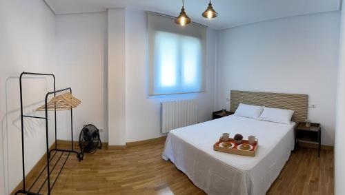 a bedroom with a bed with a box of donuts on it at El chabisque de Ner in Villamediana de Iregua