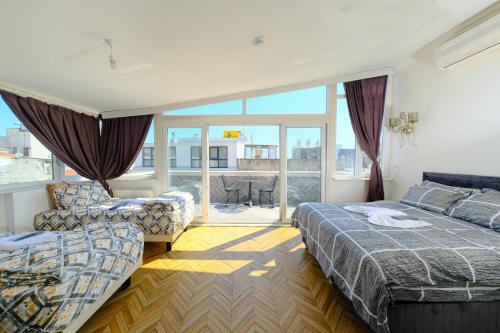 a hotel room with two beds and a balcony at Pearl Hotel İstanbul in Istanbul