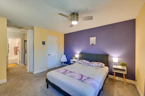 a bedroom with a large bed with a purple wall at Quiet San Diego Condo with Balcony, Pool, Hot Tub! in San Diego