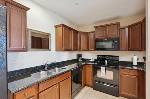 a kitchen with wooden cabinets and stainless steel appliances at 2 bedroom Tampa Condo at Private Golf Course condo in Tampa