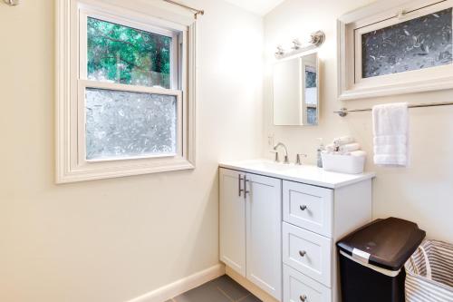 a bathroom with a sink and a window at Quaint Home with Yard about 4 Mi to Downtown Louisville! in Louisville