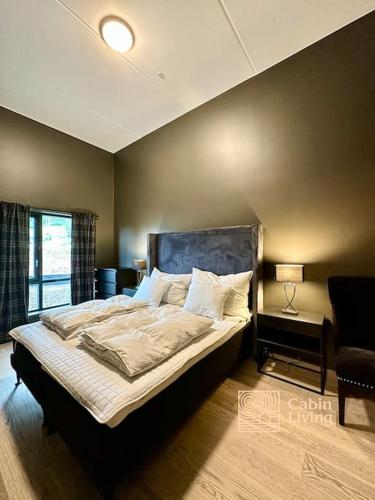 a bedroom with a bed in a room with a window at New high standard apartment in Trysil with ski in out in Trysil