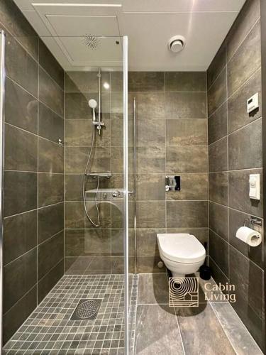 a bathroom with a shower and a toilet in it at New high standard apartment in Trysil with ski in out in Trysil