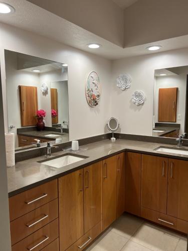 a kitchen with two sinks and a large mirror at tropical bay house in Englewood