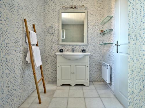 a bathroom with a white sink and a mirror at Myrto's House seaview of Naxos in Isterni