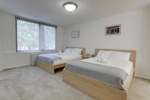 a bedroom with two beds and a window at Luxury apartment at Crystal City with Amazing Amenities in Arlington