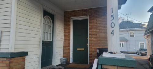 a door to a house with a green door at E. Michigan Walk Up Furnished 2 Bedroom APT in Lansing