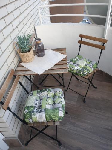 a table and two chairs on a balcony at Apartma Thermos in Krapinske Toplice