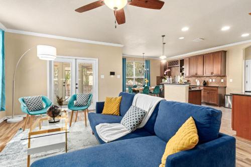 a living room with a blue couch and chairs at Cibolo Sa Getaway Wi-fi Bbq Games Parking in Cibolo