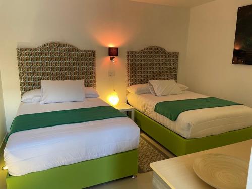 Cama o camas de una habitación en Hotel RioMiel Tlaxcala