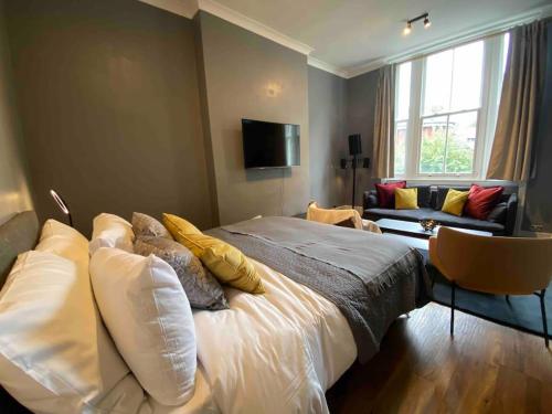 a bedroom with a large bed and a couch at Stylish Studio near Regents Park n6 in London