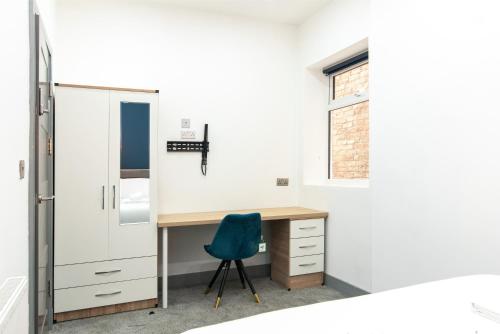 a room with a desk and a blue chair at 1BR Derby City Centre Flat 1 - Charnwood Flats in Derby