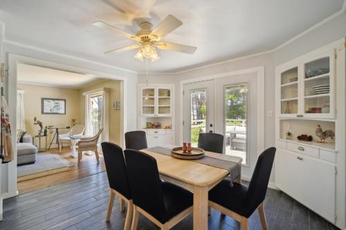 a dining room with a table and chairs and a ceiling fan at Charming Pet Friendly Coastal Getaway home in Fort Bragg