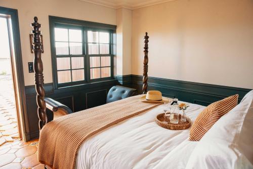 a bedroom with a large bed with two baskets on it at El Caminante Bar & Bungalows in Dana Point