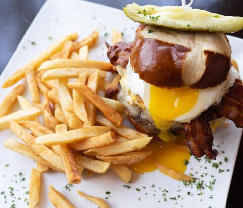 a white plate with a sandwich and french fries at Baton Rouge Marriott in Baton Rouge