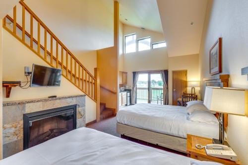 a bedroom with two beds and a fireplace at Wisconsin Dells Condo with Pool and Resort Amenities! in Wisconsin Dells