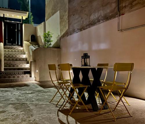 a table and chairs in a room with stairs at Comfort La tombola tripla deluxe in Naples