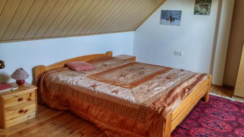 a bedroom with a wooden bed and a wooden dresser at Agroturystyka Mazury Cicha Wólka in Zawady