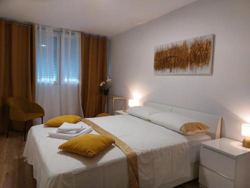a bedroom with two beds with yellow pillows at Adriatic Loridas in Split