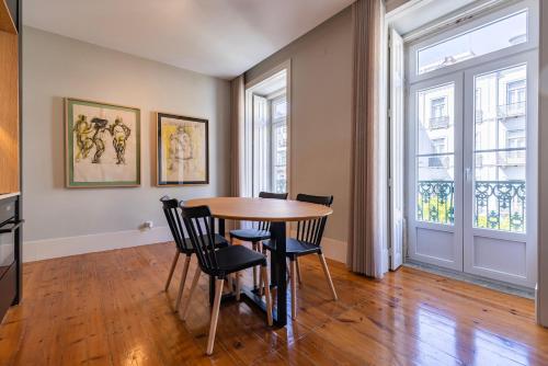 a dining room with a table and chairs and a window at Liberdade Concept 1BDR Apartment by LovelyStay in Lisbon