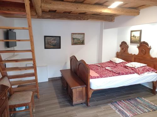 a bedroom with a bed and a ladder at Kondás ház in Döröske