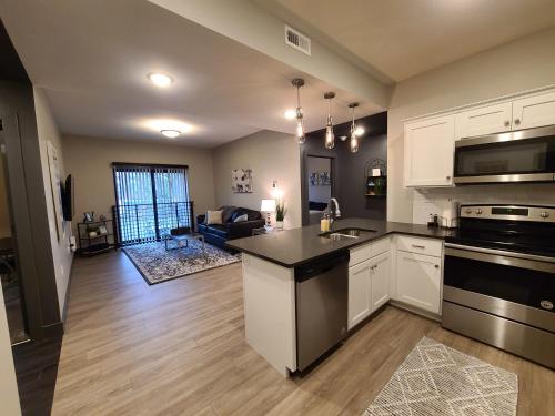 a kitchen with a sink and a stove top oven at 520 Neil Luxury 2 Bedroom in Champaign